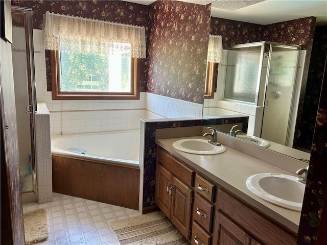 2317 Rhonda Rd, Excelsior Springs, MO 64024 - bathroom featuring wallpapered walls, a shower stall, a bath, and double vanity