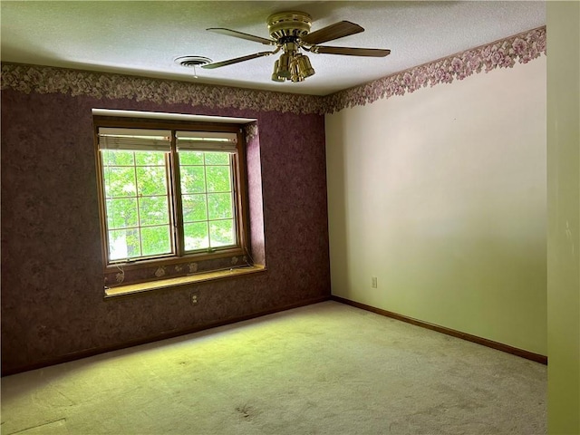 2317 Rhonda Rd, Excelsior Springs, MO 64024 - unfurnished room featuring carpet floors, a textured ceiling, ceiling fan, and baseboards
