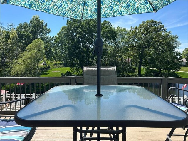 2317 Rhonda Rd, Excelsior Springs, MO 64024 - wooden terrace featuring outdoor dining space and view of wooded area