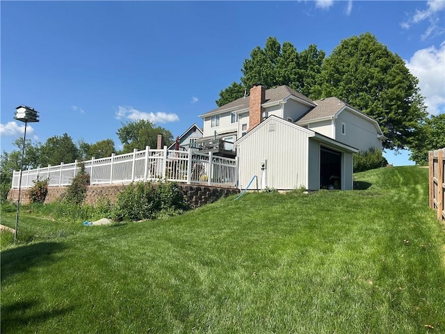 2317 Rhonda Rd, Excelsior Springs, MO 64024 - rear view of house with a lawn, an outdoor structure, a chimney, and a deck