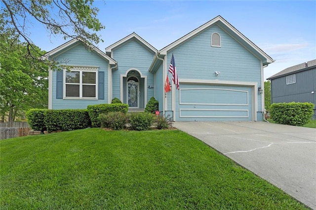 ranch-style house with a garage, fence, driveway, and a front yard