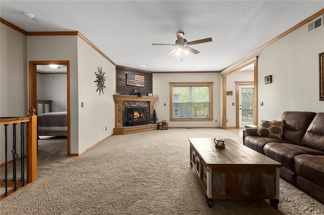 carpeted living area with crown molding, baseboards, ceiling fan, and visible vents