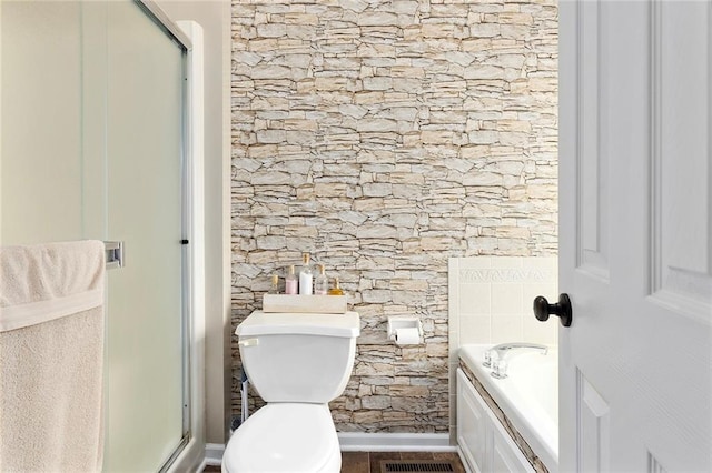 bathroom with a bath, toilet, and a shower stall
