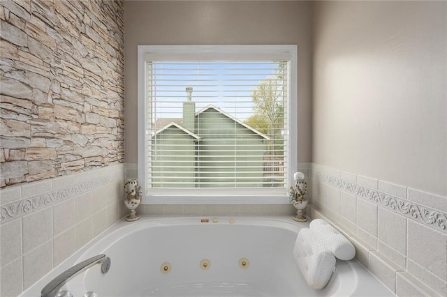 bathroom with plenty of natural light and a whirlpool tub