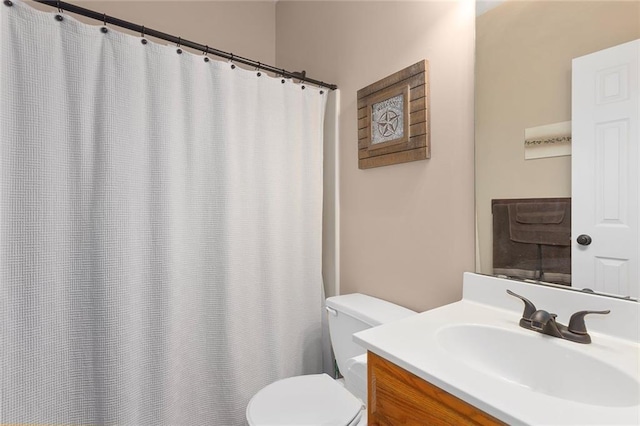 bathroom with vanity, toilet, and a shower with curtain