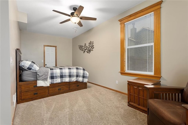 carpeted bedroom with a ceiling fan and baseboards