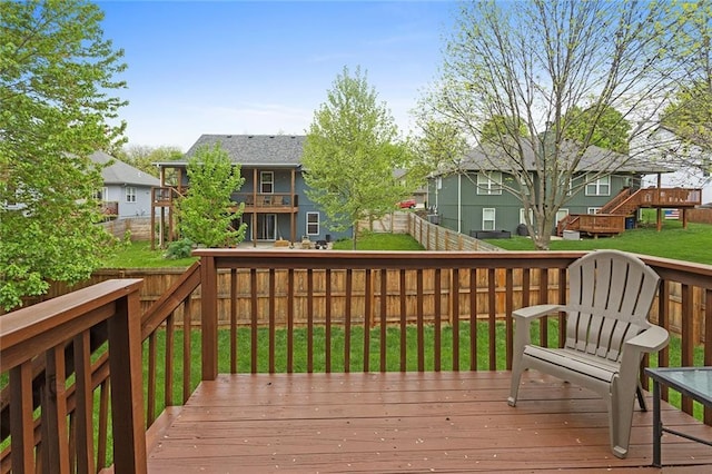 deck featuring a residential view, a yard, and a fenced backyard