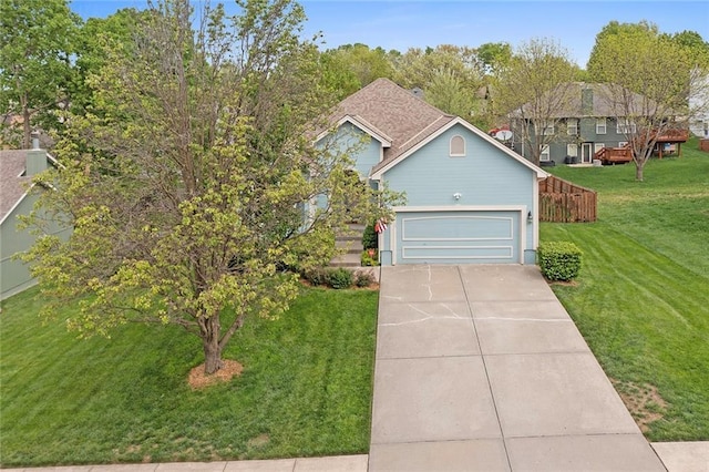 view of front of home featuring a garage, driveway, and a front yard
