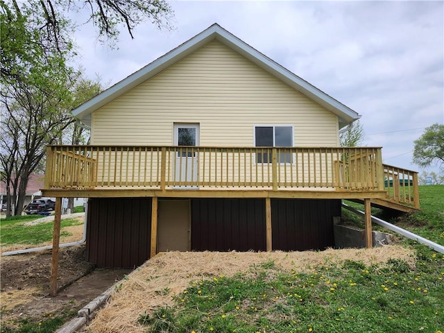 back of house with a deck