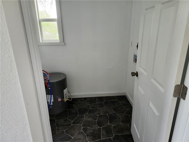 washroom with water heater, laundry area, and washer hookup