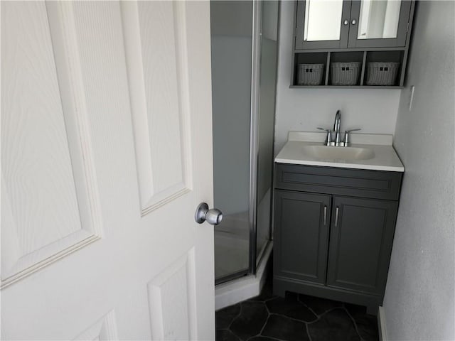full bath featuring vanity, tile patterned flooring, and a stall shower