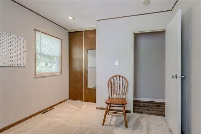 sitting room featuring baseboards and carpet flooring