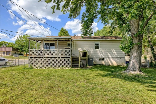 rear view of house featuring central AC unit and a wooden deck