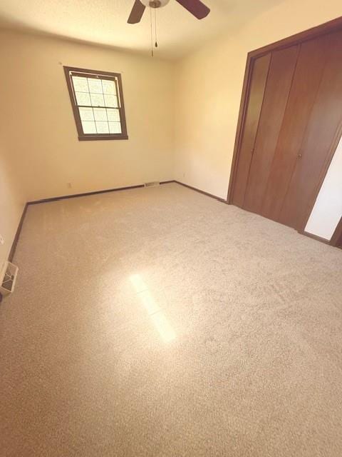 4926 Mockingbird Ln, Saint Joseph, MO 64506 - unfurnished bedroom featuring light colored carpet, a closet, and ceiling fan
