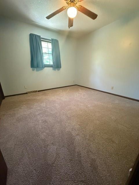 4926 Mockingbird Ln, Saint Joseph, MO 64506 - carpeted spare room featuring baseboards and ceiling fan