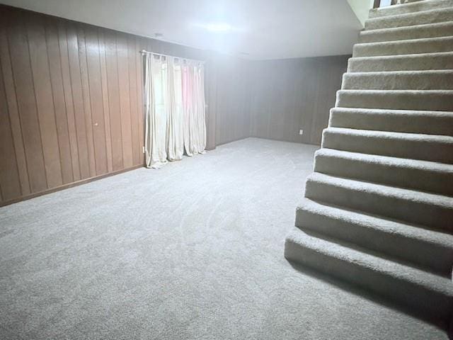 4926 Mockingbird Ln, Saint Joseph, MO 64506 - basement with carpet floors, stairway, and wood walls