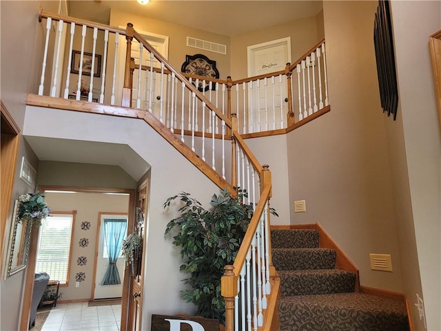 30994 W 98th St, De Soto, KS 66018 - stairs featuring baseboards, tile patterned floors, and a high ceiling