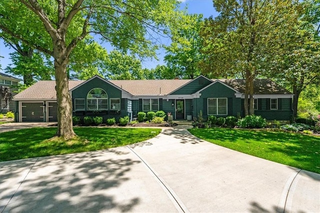 9729 Manor Rd, Leawood, KS 66206 - ranch-style home with concrete driveway, an attached garage, and a front yard