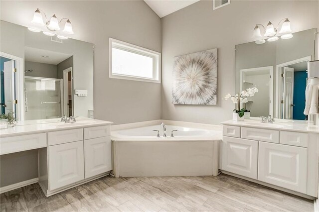14095 S Mullen St, Olathe, KS 66062 - full bath with two vanities, a shower stall, a sink, visible vents, and a garden tub