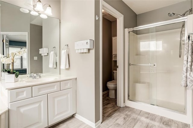 14095 S Mullen St, Olathe, KS 66062 - full bathroom with wood finished floors, a shower stall, toilet, and vanity
