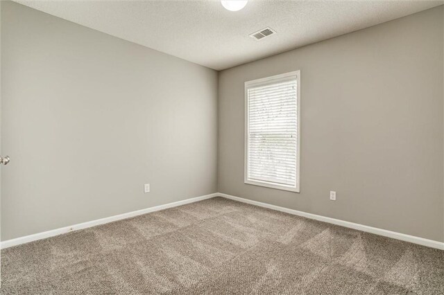 14095 S Mullen St, Olathe, KS 66062 - carpeted spare room featuring a textured ceiling, visible vents, and baseboards