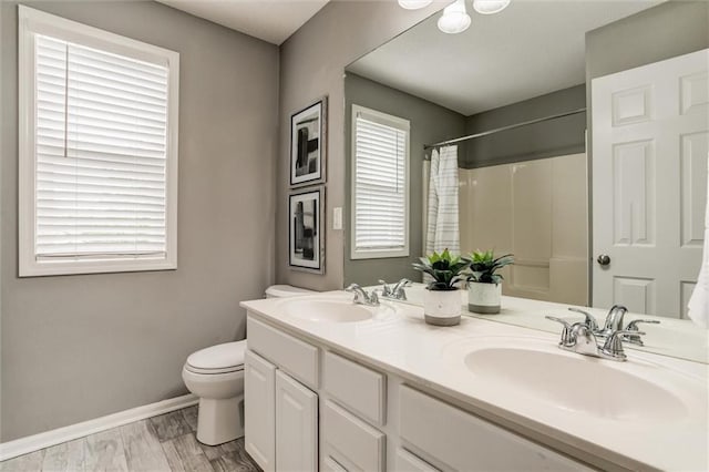 14095 S Mullen St, Olathe, KS 66062 - bathroom with toilet, baseboards, a shower with curtain, and a sink