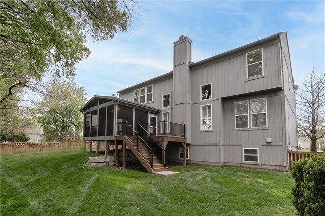 14095 S Mullen St, Olathe, KS 66062 - rear view of property featuring a chimney, a yard, fence, a sunroom, and stairs
