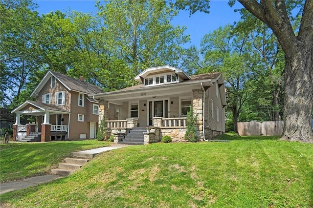 5518 Virginia Ave, Kansas City, MO 64110 - bungalow-style house with a porch and stone siding