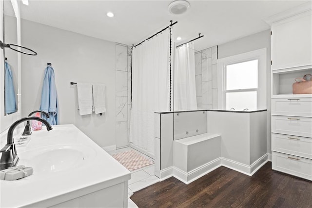 5518 Virginia Ave, Kansas City, MO 64110 - full bath with curtained shower, wood finished floors, a sink, baseboards, and recessed lighting