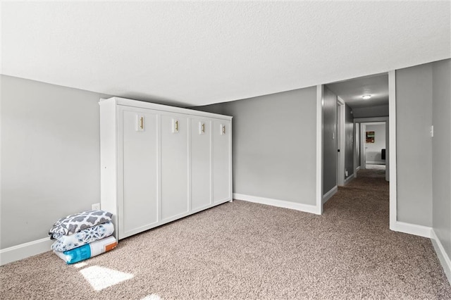 5518 Virginia Ave, Kansas City, MO 64110 - unfurnished bedroom featuring carpet flooring, baseboards, a closet, and a textured ceiling