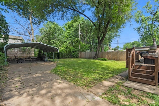 5518 Virginia Ave, Kansas City, MO 64110 - view of yard featuring a carport, a wooden deck, and driveway