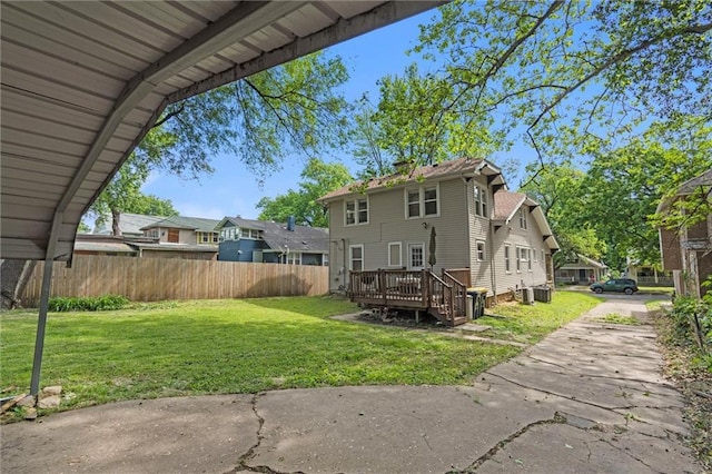 5518 Virginia Ave, Kansas City, MO 64110 - rear view of property featuring a wooden deck, central air condition unit, and a residential view