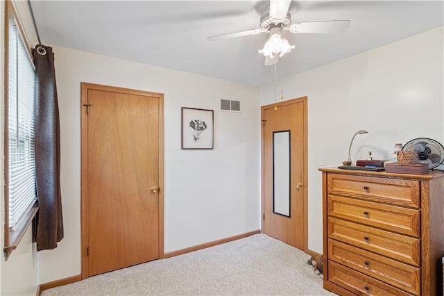bedroom featuring carpet floors, a ceiling fan, baseboards, and visible vents