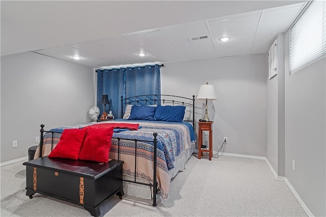 carpeted bedroom with baseboards, recessed lighting, a paneled ceiling, and visible vents