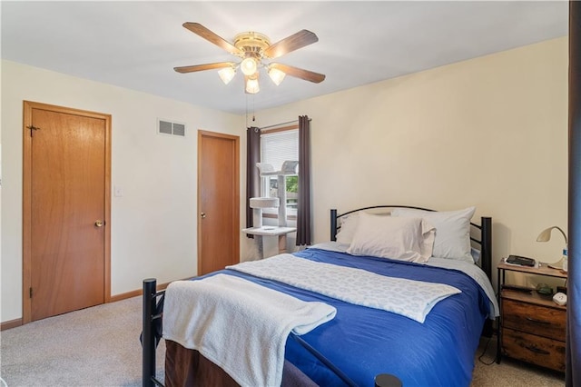 bedroom with visible vents, a ceiling fan, baseboards, and light colored carpet