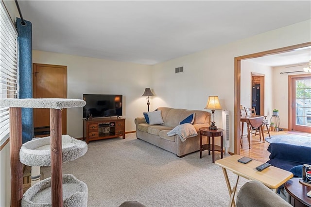 living room with visible vents and carpet floors