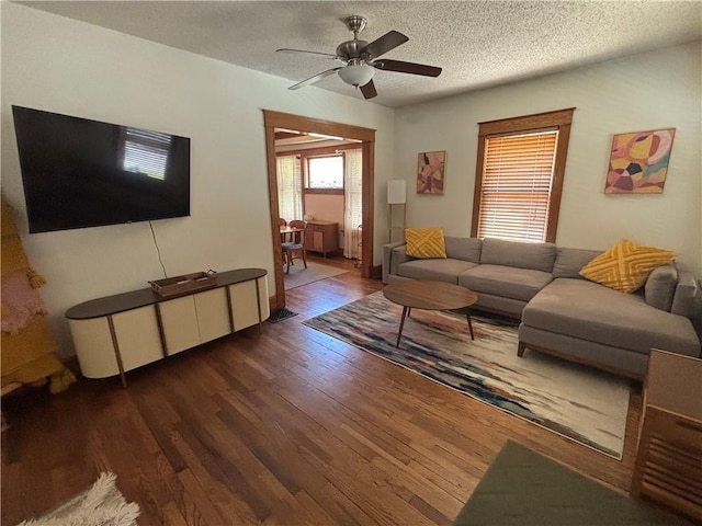 4019 Holly St, Kansas City, MO 64111 - living area with wood finished floors, a ceiling fan, and a textured ceiling
