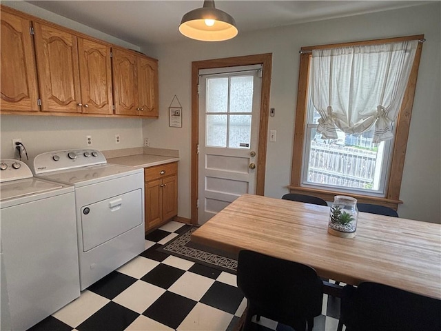 4019 Holly St, Kansas City, MO 64111 - washroom featuring washer and clothes dryer, cabinet space, and light floors