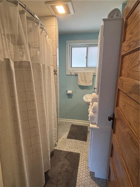 4019 Holly St, Kansas City, MO 64111 - bathroom with a shower with curtain and tile patterned flooring