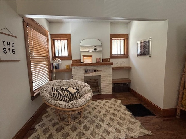 4019 Holly St, Kansas City, MO 64111 - living area with a fireplace, wood finished floors, and a ceiling fan
