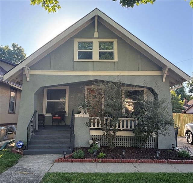 4019 Holly St, Kansas City, MO 64111 - view of front of home with covered porch and stucco siding