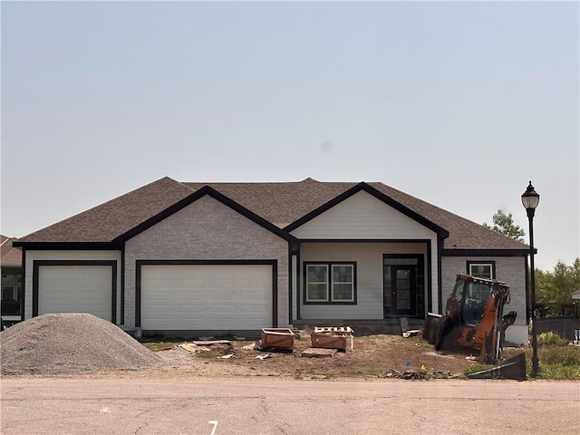 2211 Prairie Creek Dr, Kearney, MO 64060 - view of front facade featuring a garage, driveway, and a shingled roof