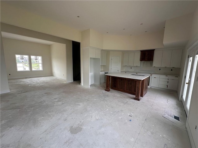 2211 Prairie Creek Dr, Kearney, MO 64060 - kitchen featuring a kitchen island, open floor plan, and white cabinets