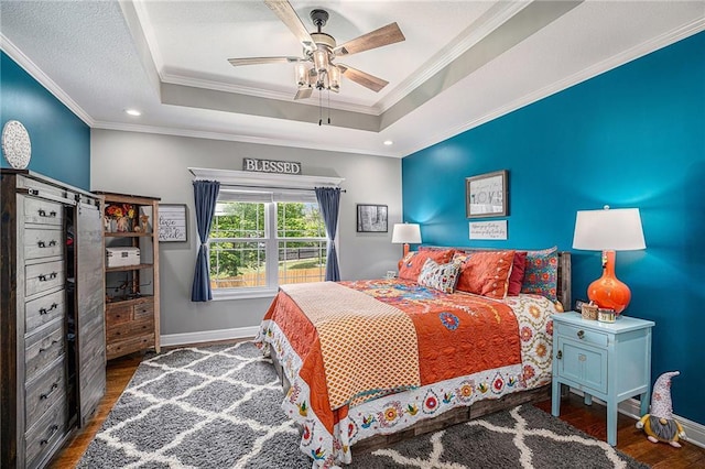 5320 N 101st Ter, Kansas City, KS 66109 - bedroom with wood finished floors, a tray ceiling, baseboards, crown molding, and ceiling fan