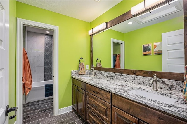 5320 N 101st Ter, Kansas City, KS 66109 - full bathroom with baseboards, double vanity, wood tiled floors, and recessed lighting