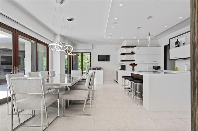 10712 W 165th St, Overland Park, KS 66221 - dining space featuring light tile patterned floors, a chandelier, and recessed lighting