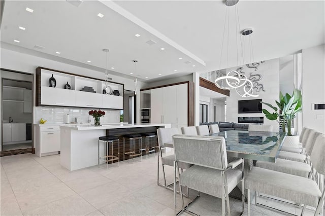 10712 W 165th St, Overland Park, KS 66221 - living area featuring a chandelier, recessed lighting, and light tile patterned floors