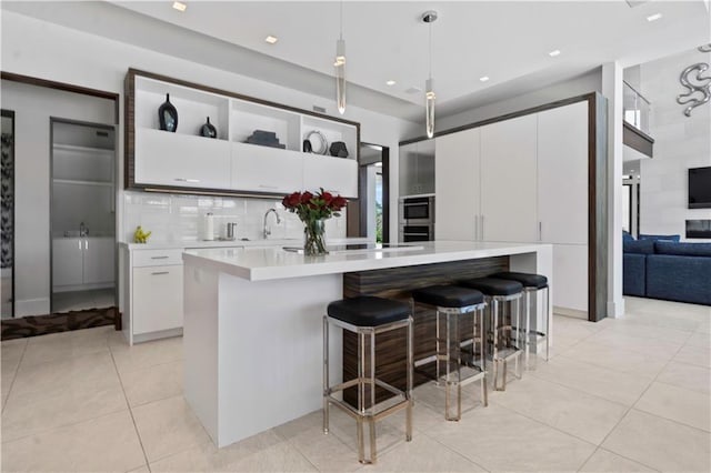 10712 W 165th St, Overland Park, KS 66221 - kitchen with light countertops, light tile patterned floors, pendant lighting, white cabinets, and recessed lighting