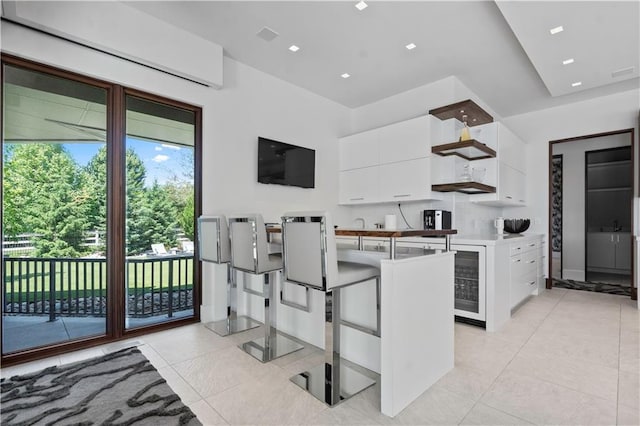 10712 W 165th St, Overland Park, KS 66221 - kitchen featuring white cabinets, light tile patterned floors, modern cabinets, and wine cooler