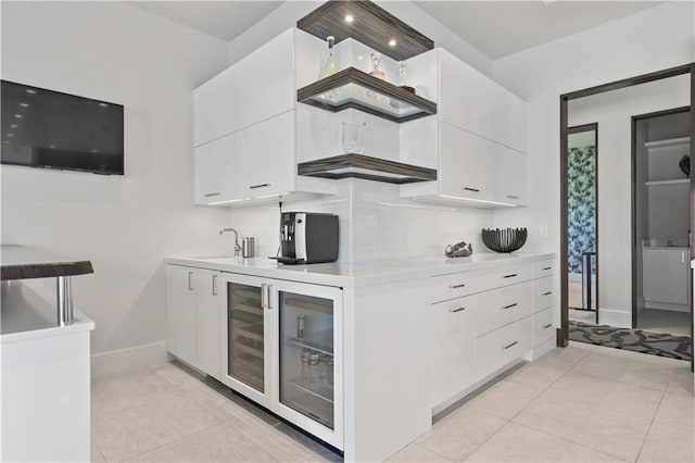 10712 W 165th St, Overland Park, KS 66221 - kitchen featuring light countertops, baseboards, white cabinets, decorative backsplash, and light tile patterned flooring